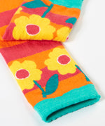 A close up of the yellow flower  design on one leg of the Frugi knitted leggings.