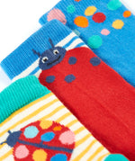 A close up of the Frugi 3 pack organic cotton socks laid flat. In a ladybird themed design and colours with a elasticated ankle cuff