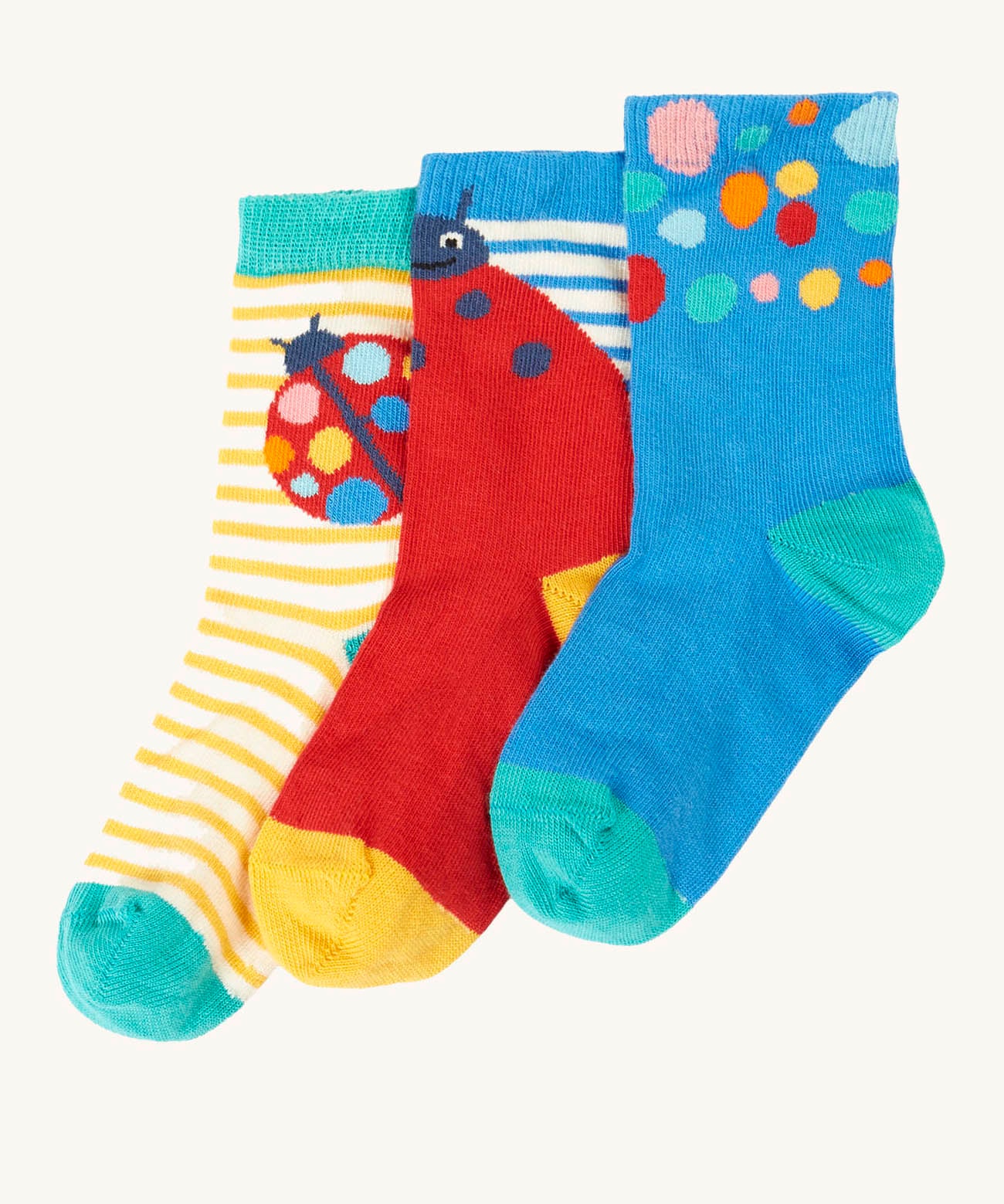 Frugi 3 pack organic cotton socks laid flat. In a ladybird themed design and colours