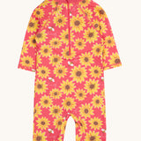 The back of the pink Frugi all in one sun safe swimwear suit with a repeating yellow sunflower and flying bee print. Features a zip from the neckline down the back