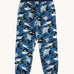 Frugi organic cotton joggers laid flat . In dark blue and navy trim with a repeating grey manta ray and shark print. 