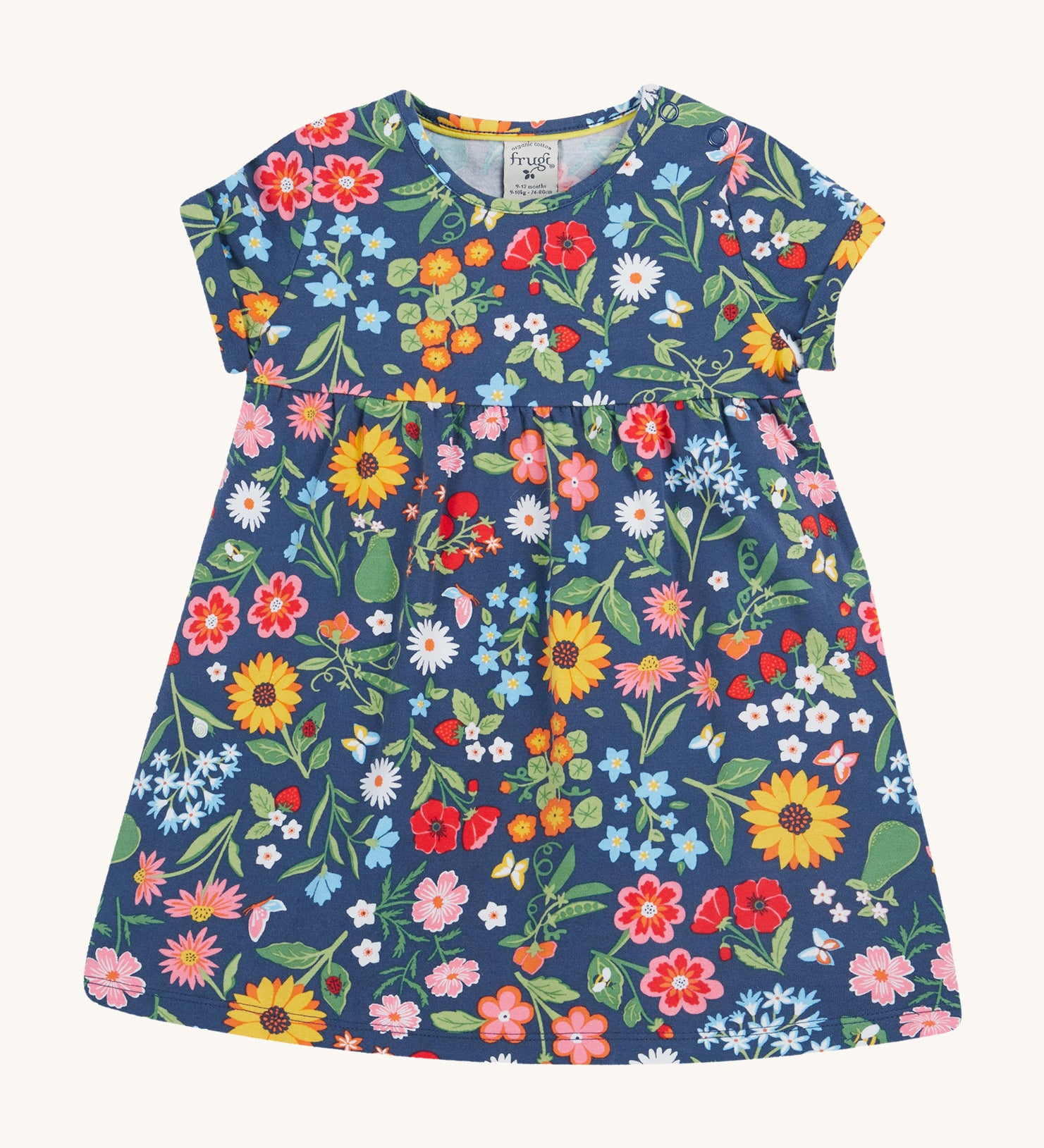 Frugi navy dress potager garden design on a cream background.
