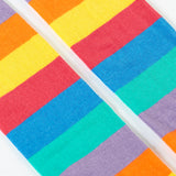 A close up of the rainbow stripe design on the bottom half of the light purple Frugi leggings.