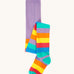 Frugi organic cotton tights laid flat. In light purple with a rainbow stripe design on the bottom half.