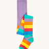 Frugi organic cotton tights laid flat. In light purple with a rainbow stripe design on the bottom half.