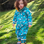 A toddler wearing the Frugi puddle buster blue panda play waterproof all in one suit with the panda wellingtons. 