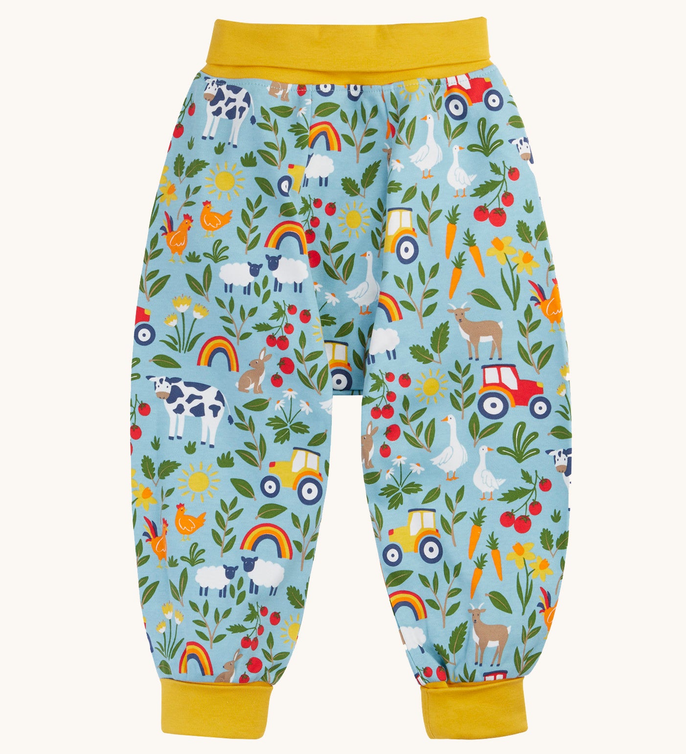 Frugi organic cotton parsnip pants laid flat in light blue and yellow trim with a repeating farm inspired print.