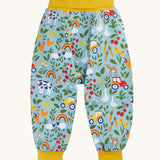 Frugi organic cotton parsnip pants laid flat in light blue and yellow trim with a repeating farm inspired print.