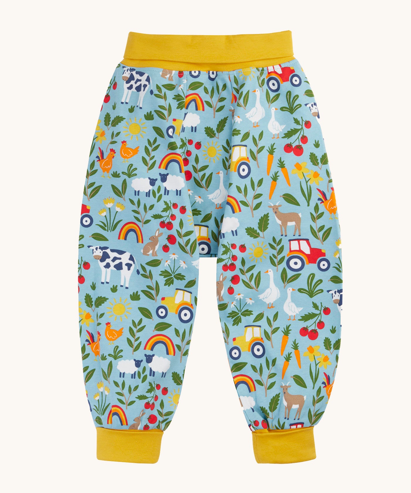 Frugi organic cotton parsnip pants laid flat in light blue and yellow trim with a repeating farm inspired print.