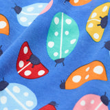 A close up of the repeated ladybird print on the Frugi parsnip pants