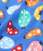 A close up of the repeated ladybird print on the Frugi parsnip pants