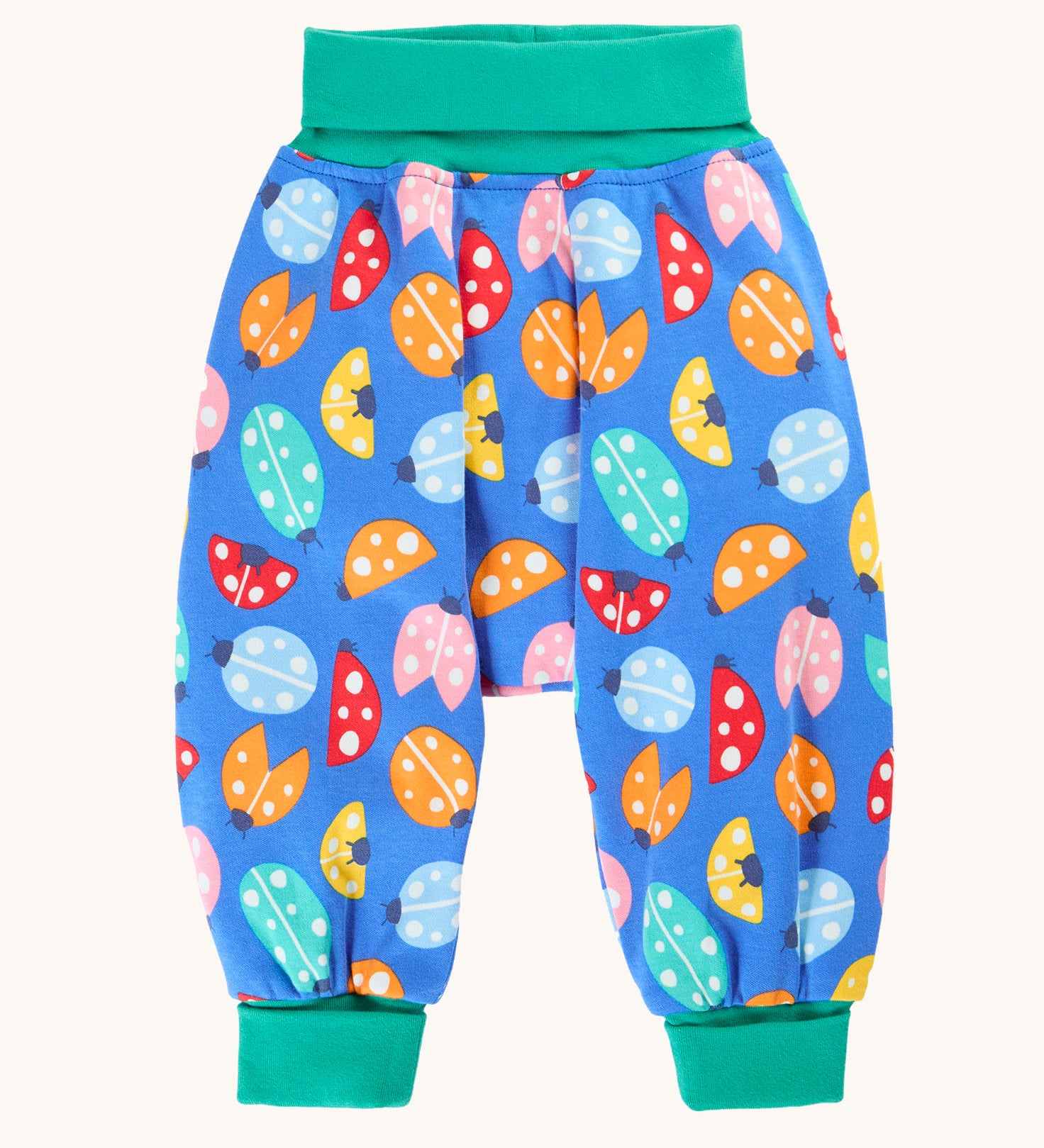 Frugi organic cotton parsnip pants laid flat in light blue and turquoise trim with a repeated ladybird print