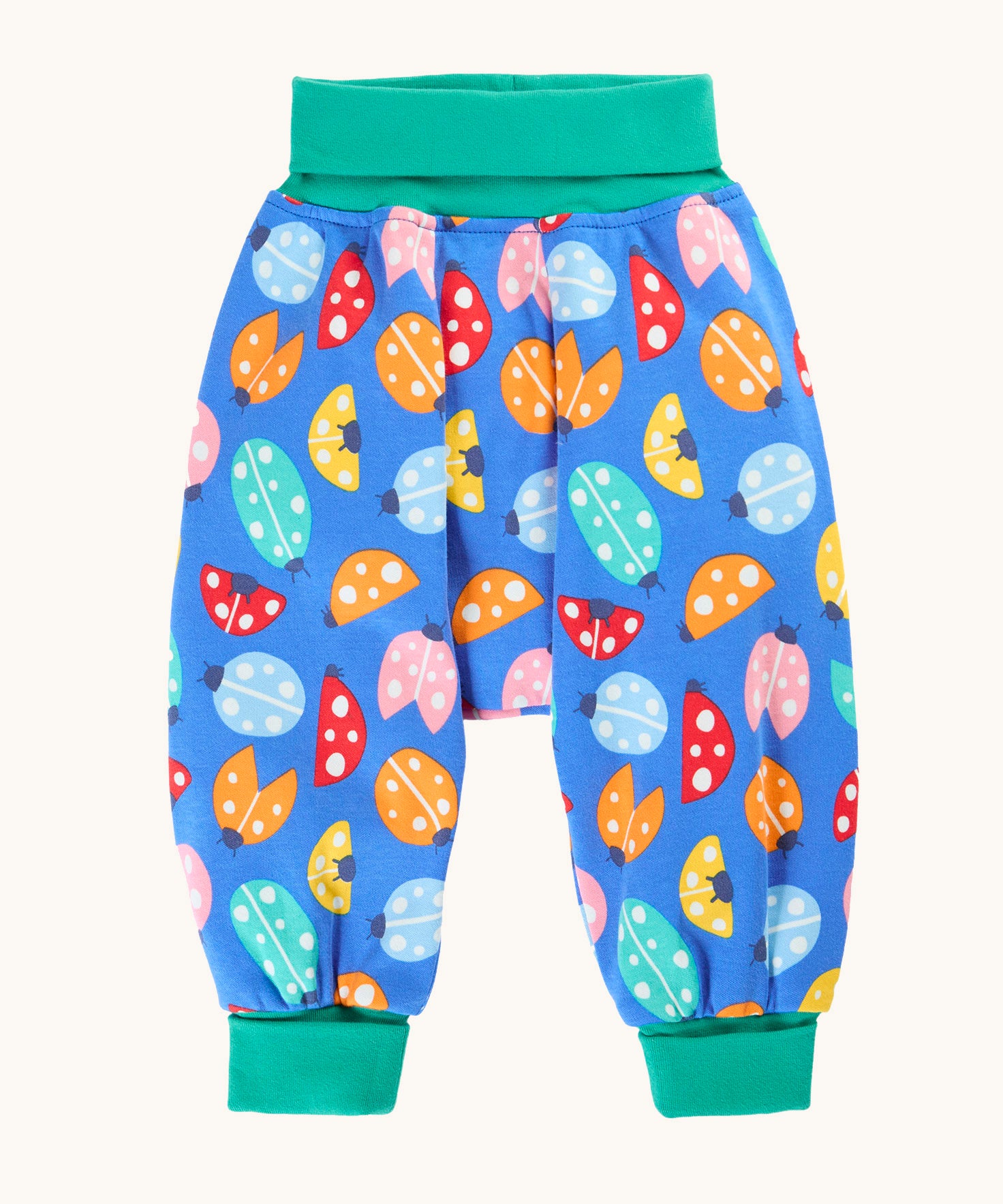 Frugi organic cotton parsnip pants laid flat in light blue and turquoise trim with a repeated ladybird print