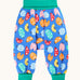 Frugi organic cotton parsnip pants laid flat in light blue and turquoise trim with a repeated ladybird print