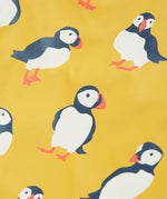 Frugi yellow puddle buster trousers puffin design print detail