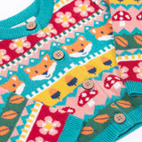 A close up of the Frugi kids robyn fairisle cardigan in fox showing the button detail and bright blue trim detail on organic cotton fabric.