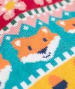 A close up of the Frugi kids robyn fairisle cardigan in fox showing the woodland inspired fairisle design detail on organic cotton fabric.