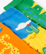 A close up of the reptile themed Frugi 3 pack organic cotton socks laid flat showing the elasticated cuff
