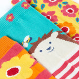 A close up of the garden themed Frugi 3 pack organic cotton socks laid flat showing the elasticated cuff