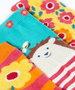 A close up of the garden themed Frugi 3 pack organic cotton socks laid flat showing the elasticated cuff