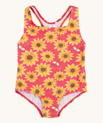 Frugi recycled plastic swimsuit laid flat. In pink with a repeating yellow sunflower and bee design.