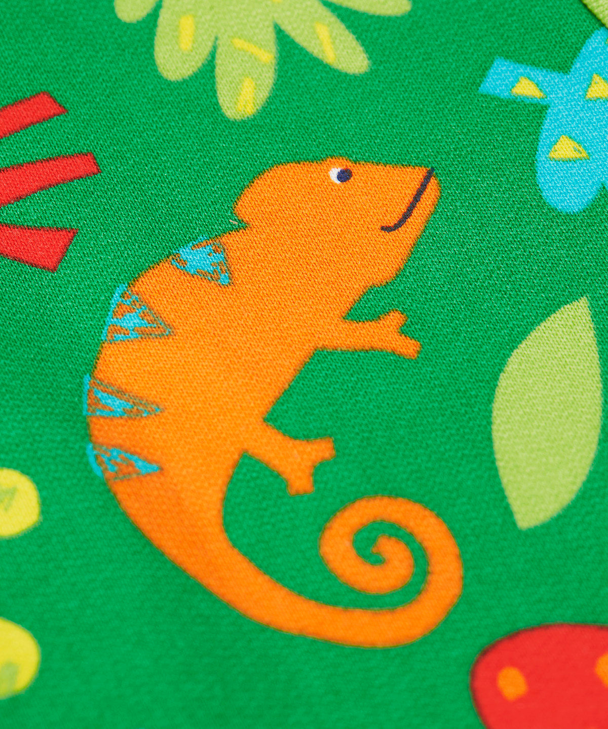 A close up of the orange chameleon design on the Frugi green samson printed shorts