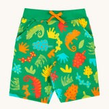 Frugi samson printed shorts laid flat. In bright green with a repeated chameleon and leaves print. Features a orange waist tie