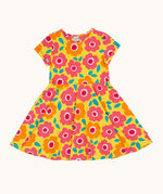 Frugi skater dress laid flat. In bright yellow with a repeating pink and orange floral print