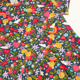 A close up of the navyFrugi organic cotton skater dress laid flat  showing the repeating heart, sun rainbow and flower print.