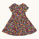 Frugi organic cotton skater dress laid flat. In navy with a repeating heart, sun rainbow and flower print.