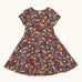 Frugi organic cotton skater dress laid flat. In navy with a repeating heart, sun rainbow and flower print.