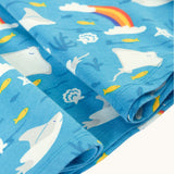 A close up of the light blue manta ray Frugi skater dress laid flat showing the frill detail 