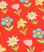 A close up of the repeating pastel flower print ont the frugi red sweatshirt