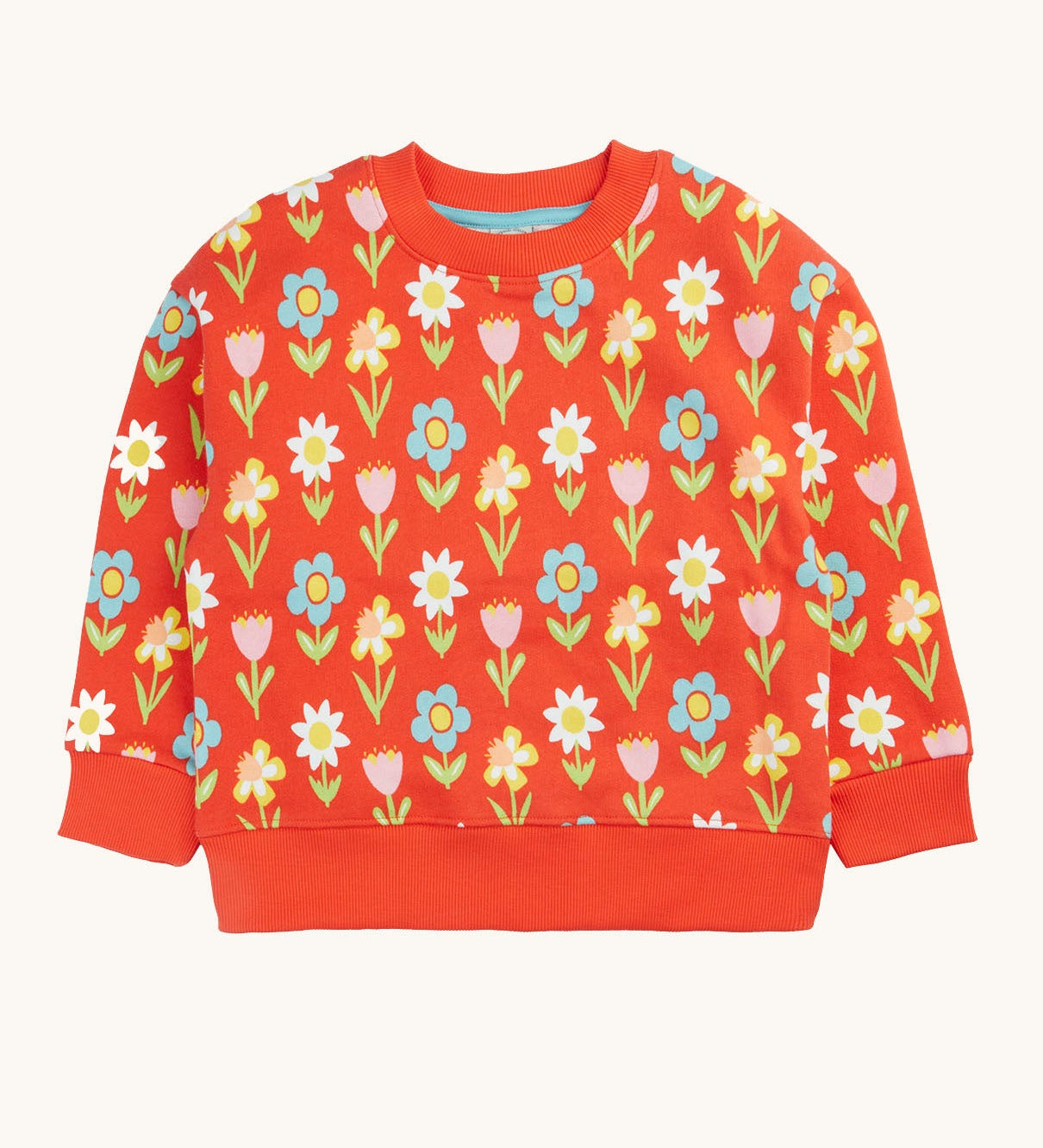 Frugi organic cotton sweatshirt laid flat. In red with a repeating pastel coloured flower print.