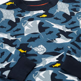 A close up of the Frugi organic cotton sweatshirt laid flat. In dark blue and navy trim with a repeating grey manta ray and shark print.