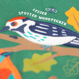 A close up of the Frugi kids terrific applique top in holly green/birds showing the woodpecker applique detail on dark green organic cotton fabric.