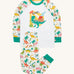 Frugi white pyjama set dinoland design on a cream background.