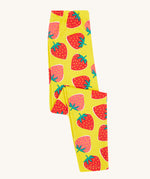 Frugi yellow leggings strawberry patch design folded on a cream background