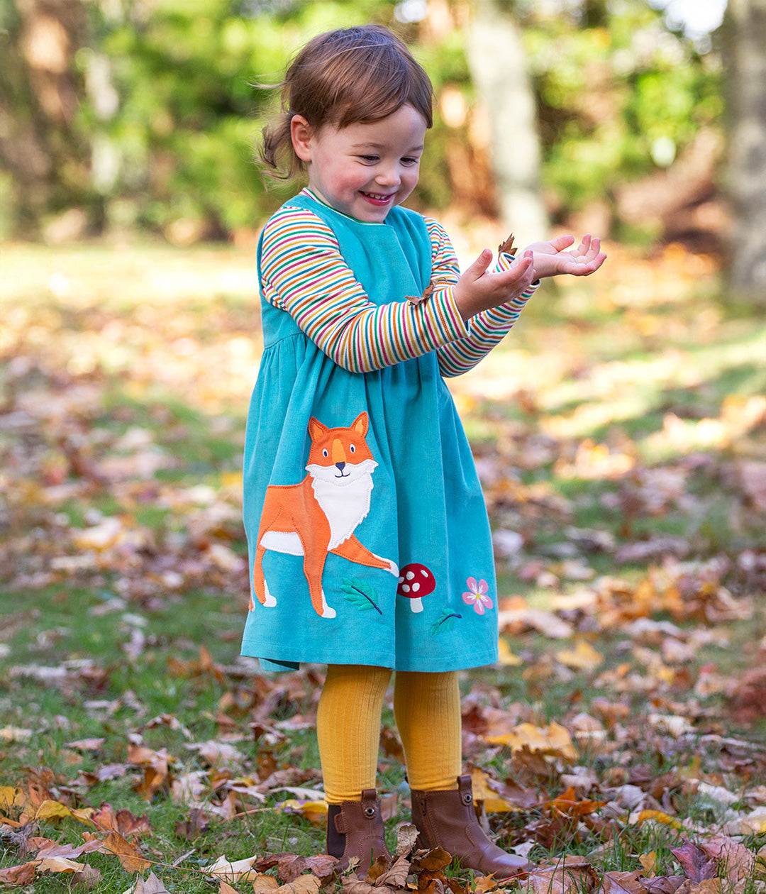 Child wearing fox cord dress from the Frugi Organic cotton clothing range for kids available at Babipur. 