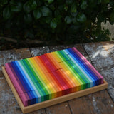 Glückskäfer 64 building slats in flat storage box tray placed on a wooden surface.