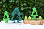 Glückskäfer 6-Piece Fir Tree wooden tree stacking toy pieces all lined up net to each other.