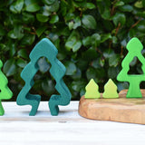 Glückskäfer 6-Piece Fir Tree wooden tree stacking toy pieces all lined up net to each other.