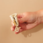 Person demonstrating how to fold a HEVEA LOOP menstrual cup.