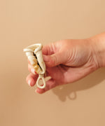 Person demonstrating how to fold a HEVEA LOOP menstrual cup. 