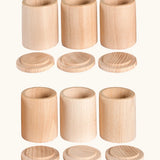 A set of 6 Grapat handcrafted unpainted wooden cups with matching lids, perfect for sorting and creative play
