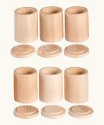 A set of 6 Grapat handcrafted unpainted wooden cups with matching lids, perfect for sorting and creative play