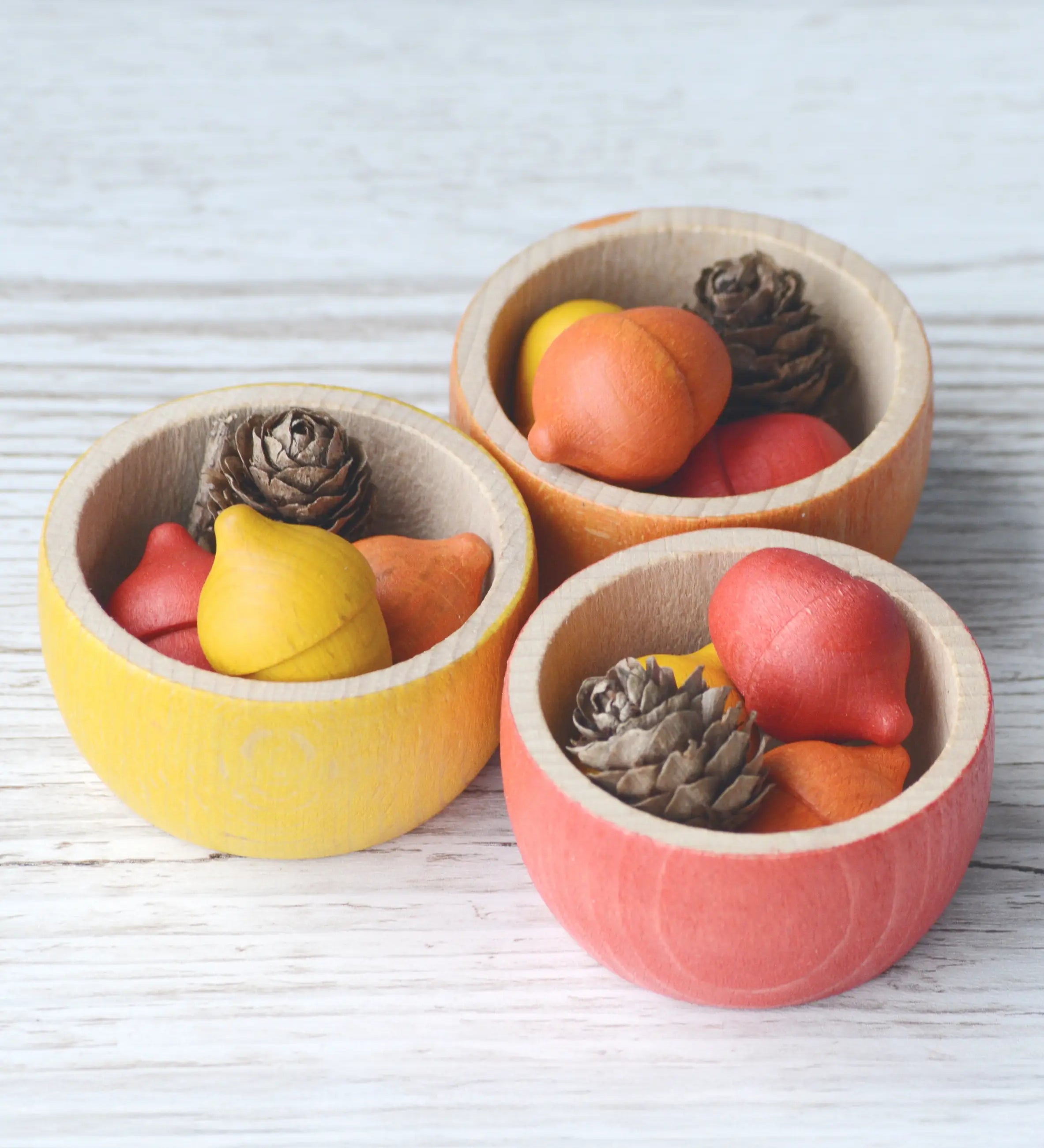 3 Grapat handcrafted wooden bowls with small coloured acorns inside 