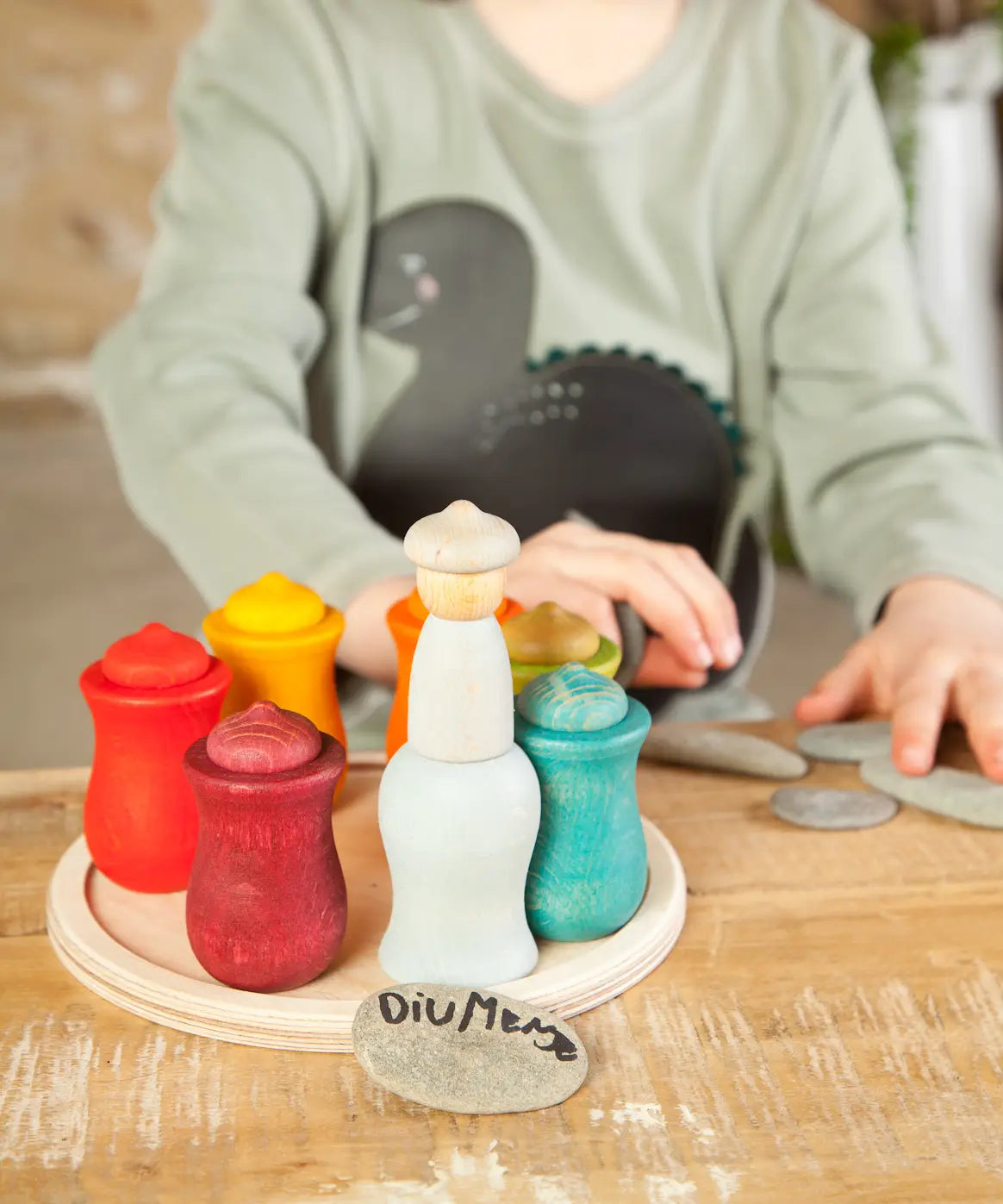 A handcrafted wooden Grapat 7 moons weekly calendar set standing on a wooden table