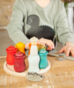 A handcrafted wooden Grapat 7 moons weekly calendar set standing on a wooden table