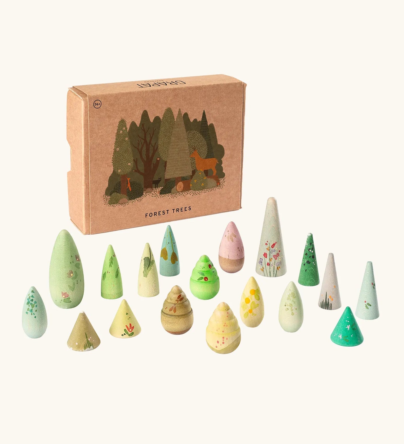 Grapat forest trees set showing handcrafted pastel colour wooden cone pieces standing next to a decorated cardboard storage box